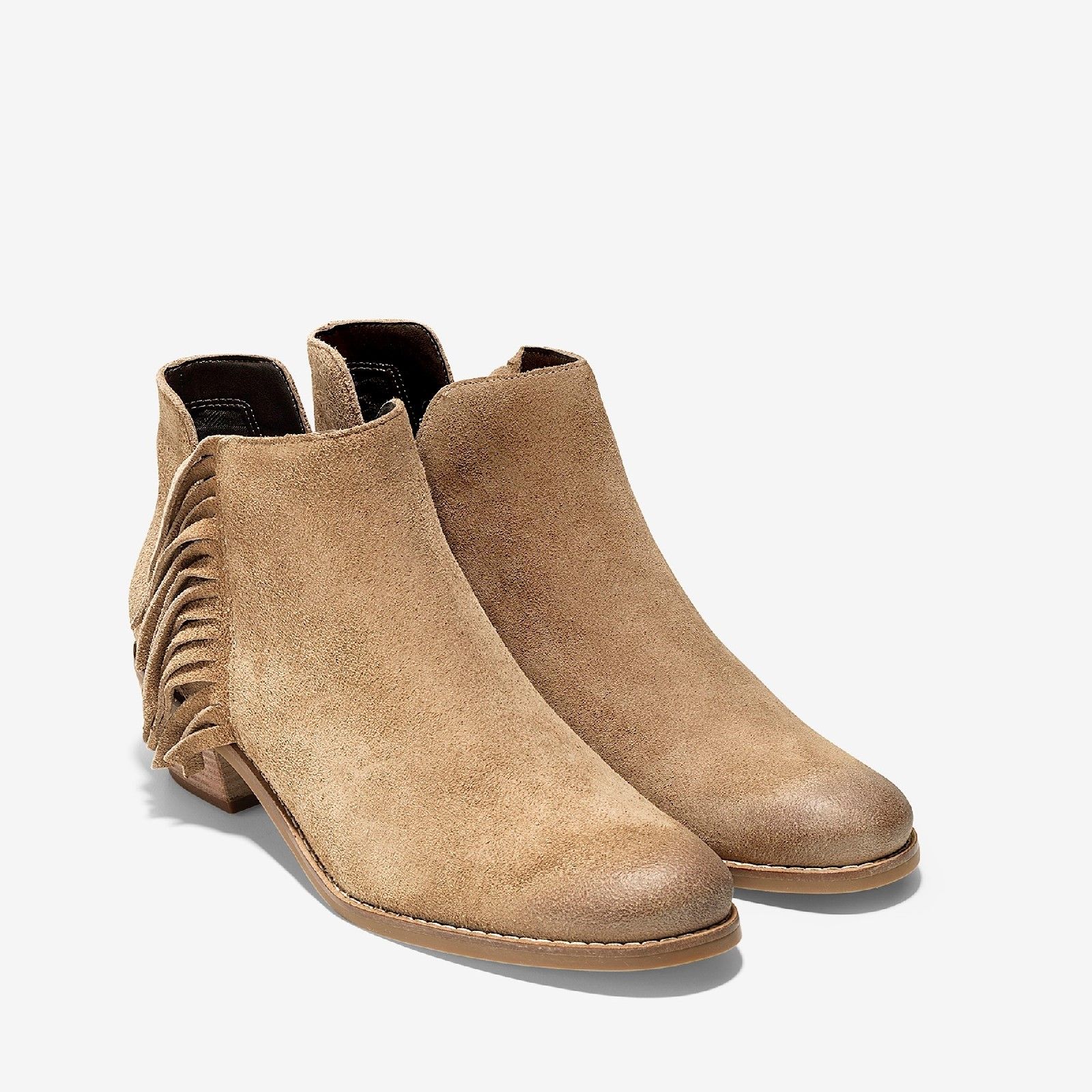 These urban, cowgirl-chic ankle boots are crafted in rich leather and feature dual side cut-outs that add the perfect amount of edgy flair. Suede upper with fringe detail and hidden side gore for easy entry.. 
Fully lined.. 
Full rubber outsole with welt and GRAND/OS technology for comfort and stability.. 
45mm stacked heel..