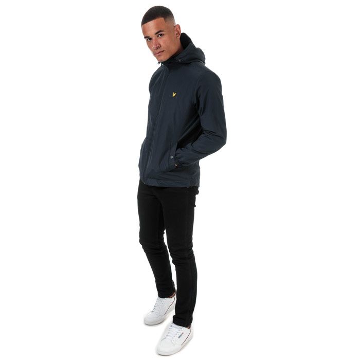 Mens Lyle And Scott Microfleece Lined Zip Through Hooded Jacket in dark navy.<BR><BR>Lightweight shell jacket with warm microfleece body lining.<BR>- Bungee-adjustable hood.<BR>- Full zip fastening.<BR>- Long sleeves with elasticated cuffs.<BR>- Side welt pockets with snap closure.<BR>- Bungee-adjustable hem.<BR>- Embroidered eagle logo at left chest.<BR>- Shell: 100% Nylon.  Body and sleeve lining: 100% Polyester.  Machine washable.<BR>- Ref: JK921VZ271