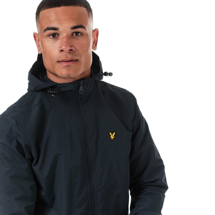 Mens Lyle And Scott Microfleece Lined Zip Through Hooded Jacket in dark navy.<BR><BR>Lightweight shell jacket with warm microfleece body lining.<BR>- Bungee-adjustable hood.<BR>- Full zip fastening.<BR>- Long sleeves with elasticated cuffs.<BR>- Side welt pockets with snap closure.<BR>- Bungee-adjustable hem.<BR>- Embroidered eagle logo at left chest.<BR>- Shell: 100% Nylon.  Body and sleeve lining: 100% Polyester.  Machine washable.<BR>- Ref: JK921VZ271