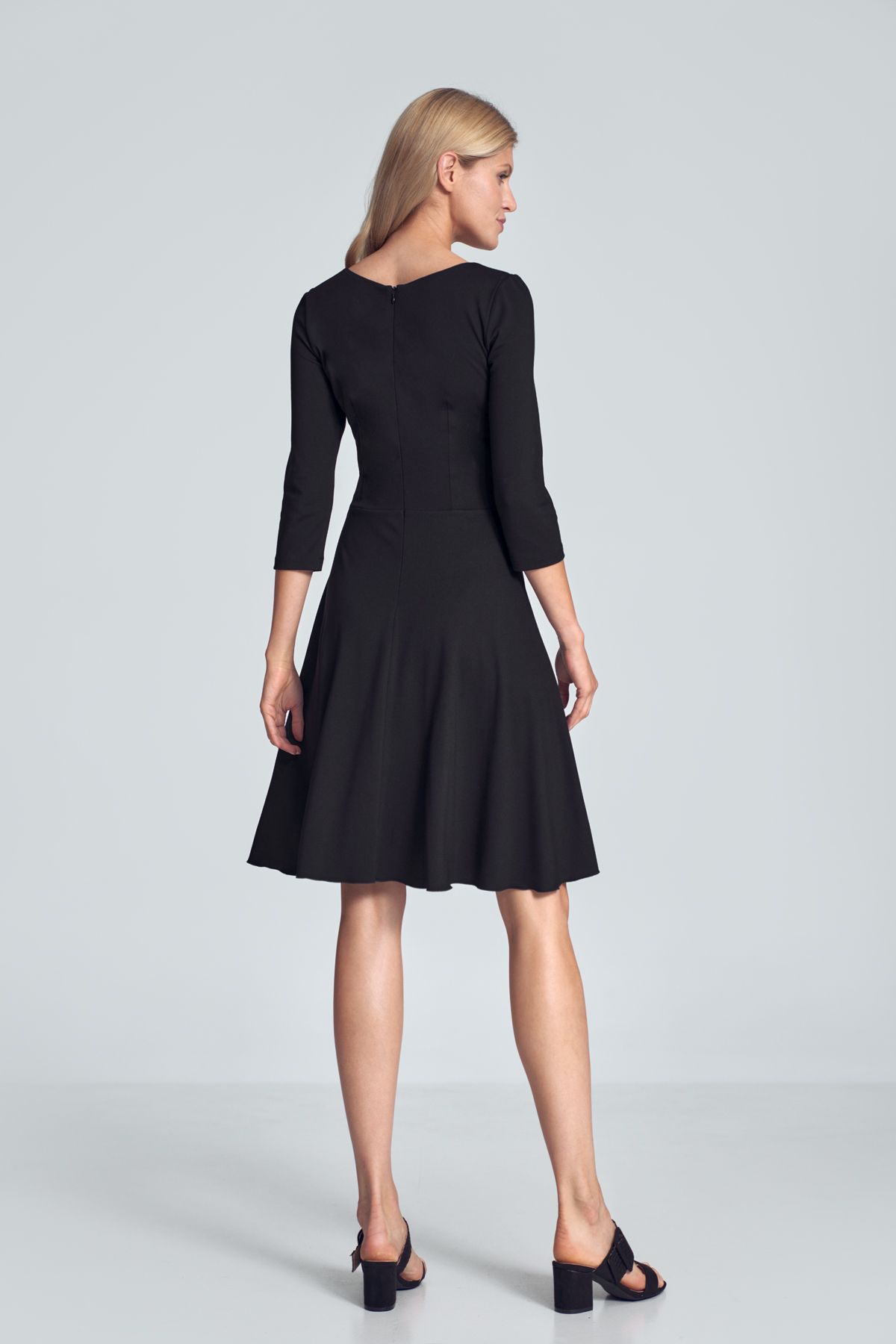 Black cocktail midi dress with a V-neck, ¾ sleeve, pleats at the bust, sewn at the waist, flared hem. Fastened at the back with a covered zipp.
