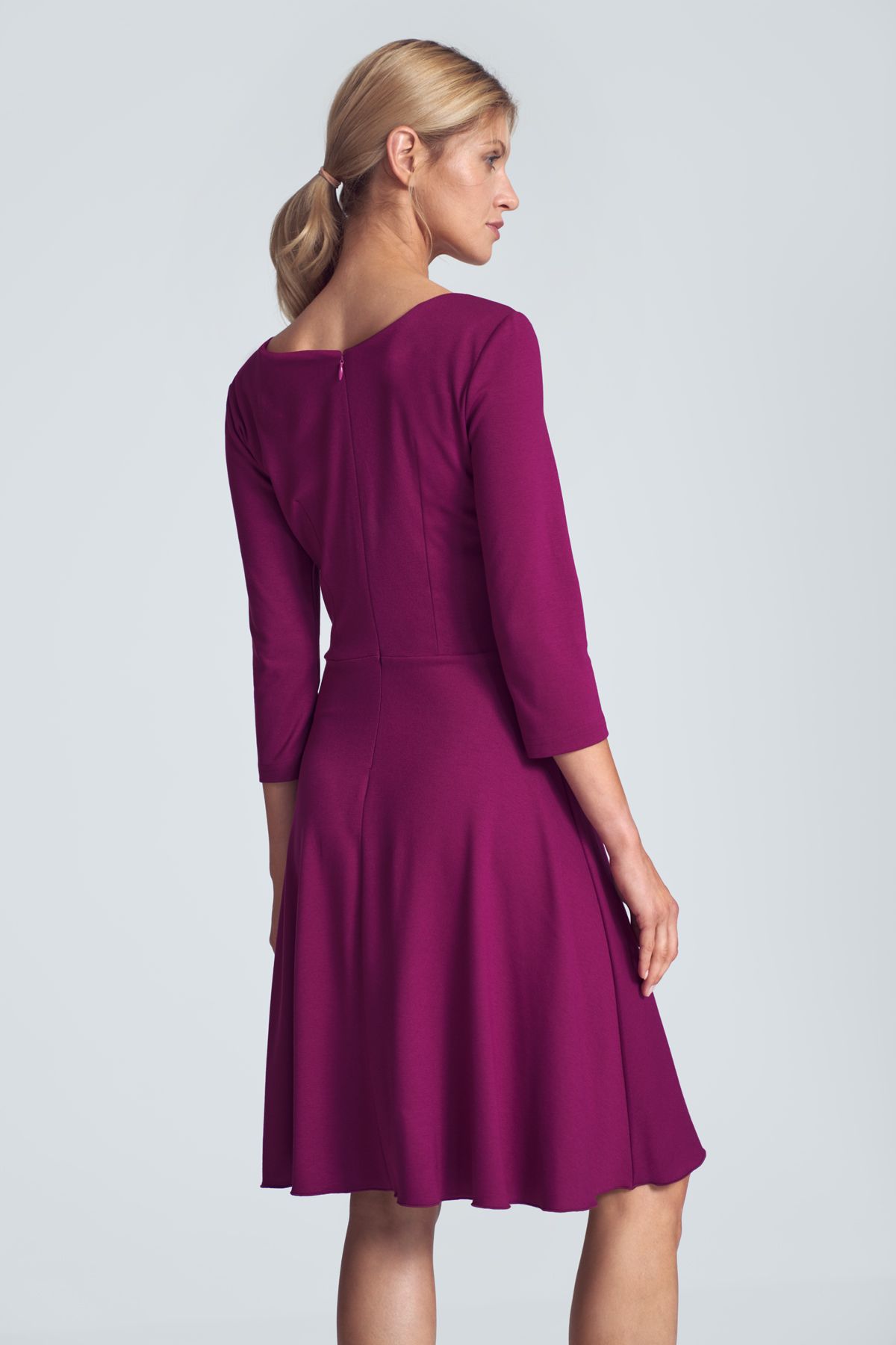 Fuchsia cocktail midi dress with a V-neck, ¾ sleeve, pleats at the bust, sewn at the waist, flared hem. Fastened at the back with a covered zipp.