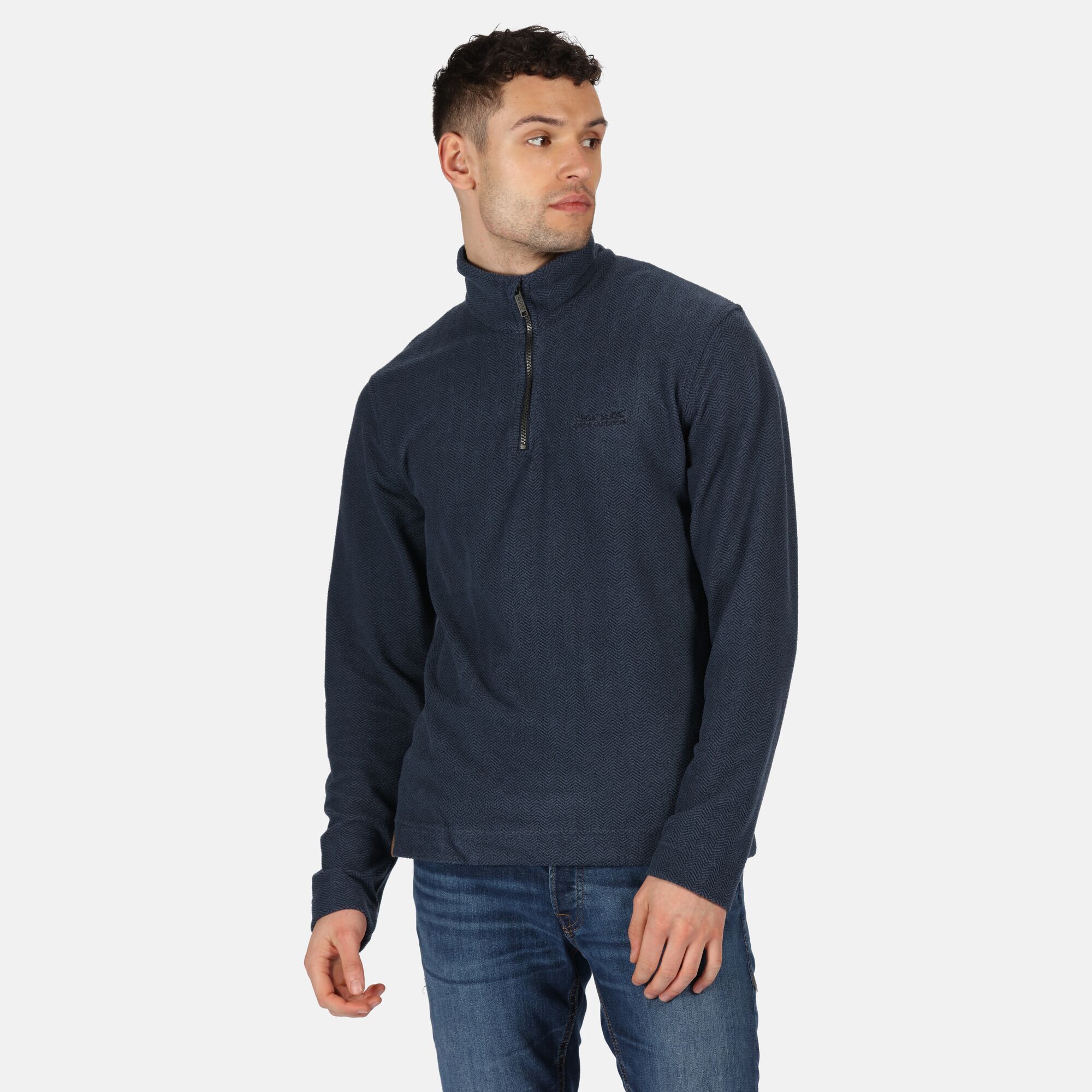 Material: 96% Polyester, 4% Elastane. Lightweight fleece pullover with a subtle herringbone pattern and zip neck. Breeze blocking stand collar. Regatta outdoors badge on the left sleeve.