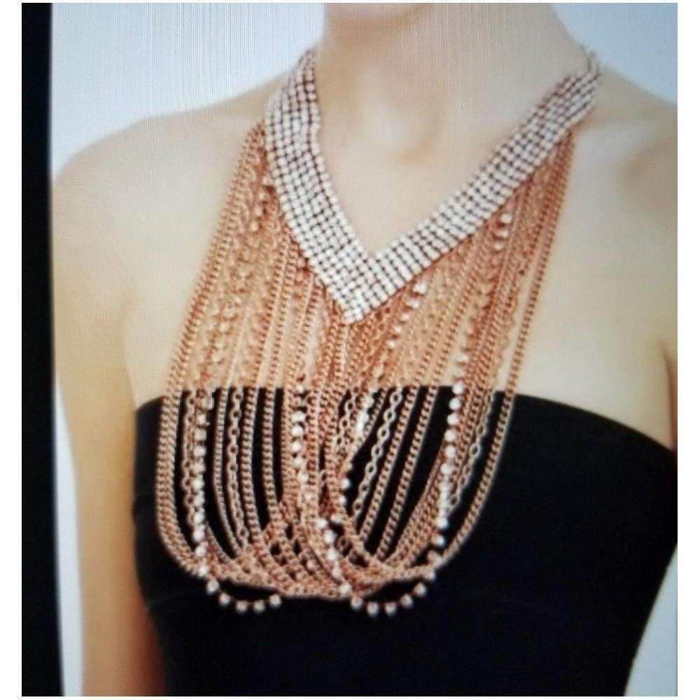 Add dramatic appeal to simple looks with this gleaming chain necklace. V-shaped rhinestone detail. Draped mixed-metal chains and glass pearls. Lobster-clasp closure. Copper, Iron, Glass.