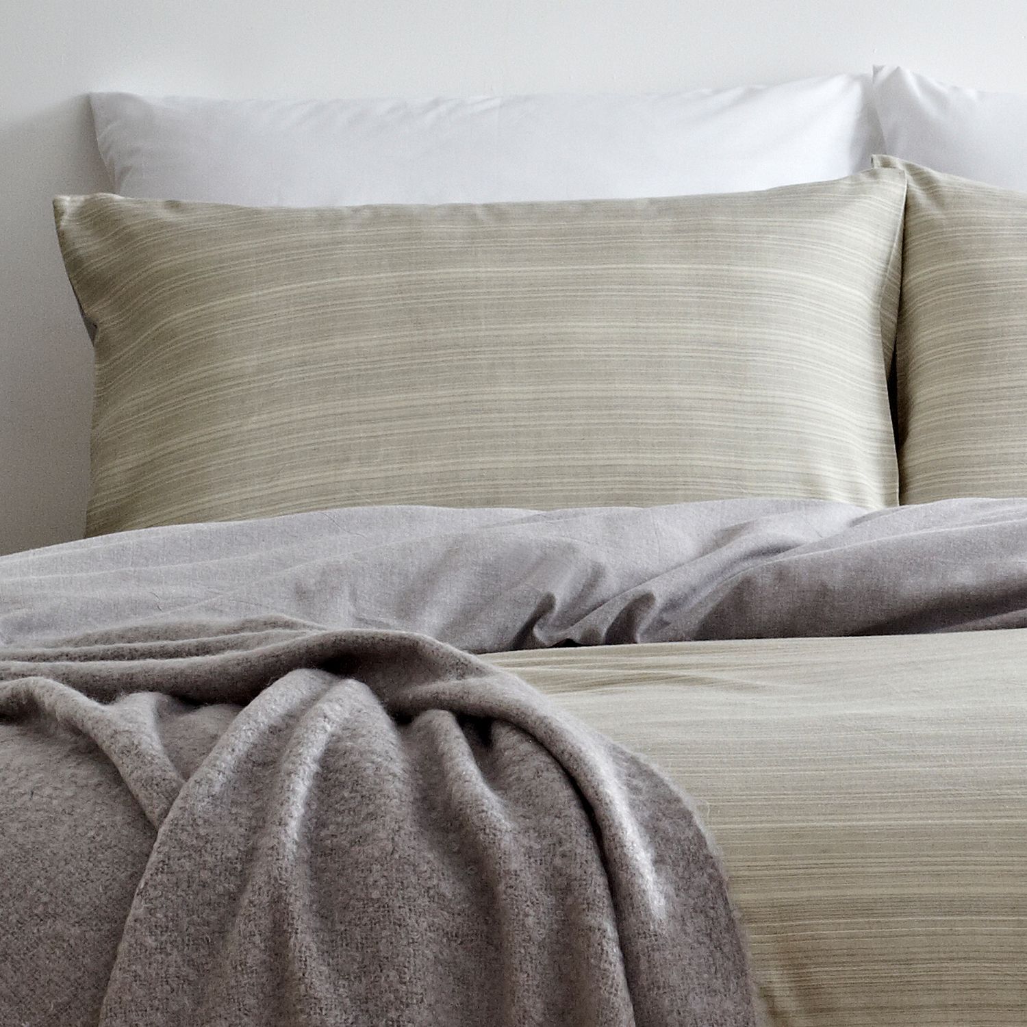 Create a signature look with this perfectly relaxed duvet cover and pillow case set. With soft earthy tones, this design creates a warm and restful mood. The reversible design allows the subtle ombre effect to give a natural textured apperance whilst the chambray grey reverse is ultra versitable for any bedroom.