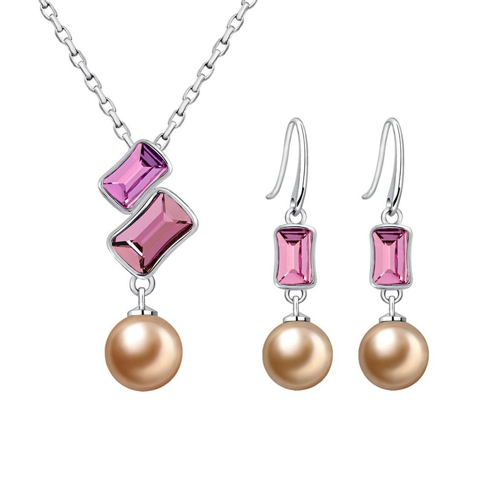 Pearl and Pink Swarovski Elements Crystal Set Consists of a pendant and a pair of dangling earrings, perfect combination of pearl and crystal for a fresh, modern design. Description of pendant: Gold pearl crystal and Swarovski Elements light pink and dark pink Dimension: 3 x 1.5 cm Length of the chain: 40 cm adjustable Description of the earrings: Gold pearl and Swarovski Elements crystal clear pink Hanging hook Dimension: 3.5 x 0.8 cm Rhodium-plated frame.
