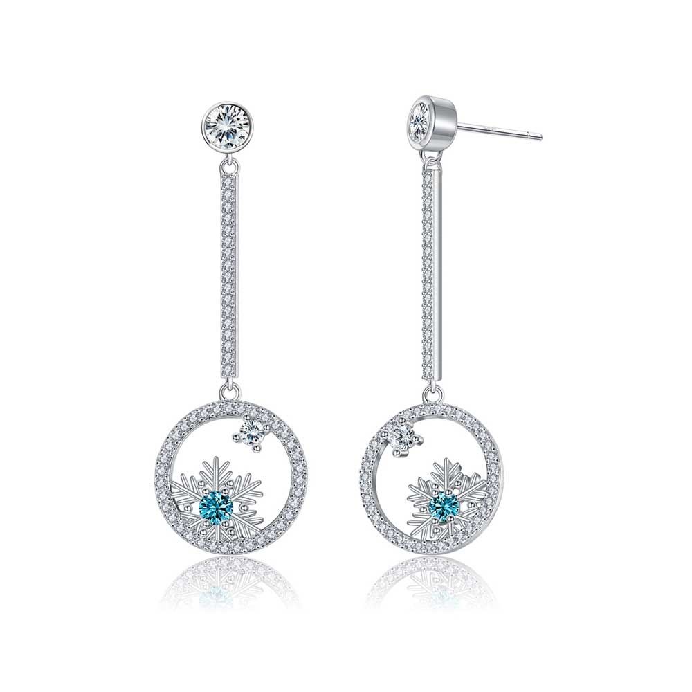 Snowflake Dangling Earrings Pair of snowflake-shaped dangling earrings made of white Swarovski crystals and a blue central crystal. Frame rhodium plated. Dimension: 4.4 x 1.5 cm
