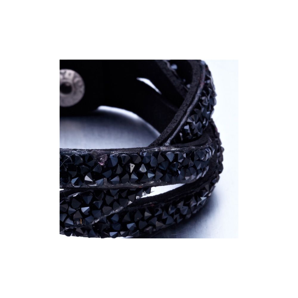 Black Swarovski Crystal Elements and Leather Interlaced Bracelet This beautiful bracelet leather black color is composed of 3 interlaced rows. These rows are set with a multitude of black Swarovski Elements crystals with intense reflections. The clasp, stainless steel is double pressure for easy and quick handling. This bracelet sparkles and you sublimate at your parties! Dimensions: 20 cm x 2.3 cm Succumb to the beauty of this bracelet that will not disappoint.