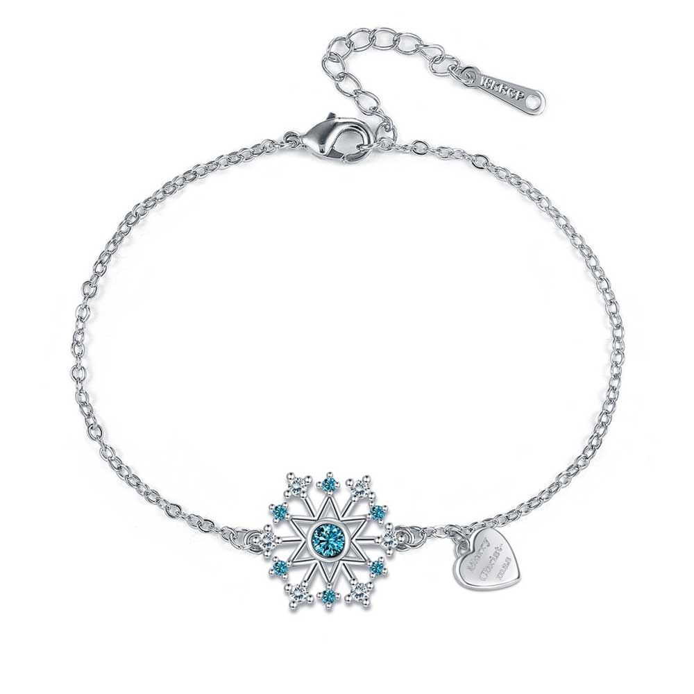 Set: Snowflake Bracelet and Earrings 1- Snowflake Earrings White and blue Swarovski crystals Rhodium-plated frame Dimension: 1 x 1 cm Pushchair clasp 2- Snowflake Bracelet White Swarovski crystals and a blue crystal. A small heart-shaped pendant completes the bracelet, inscription 