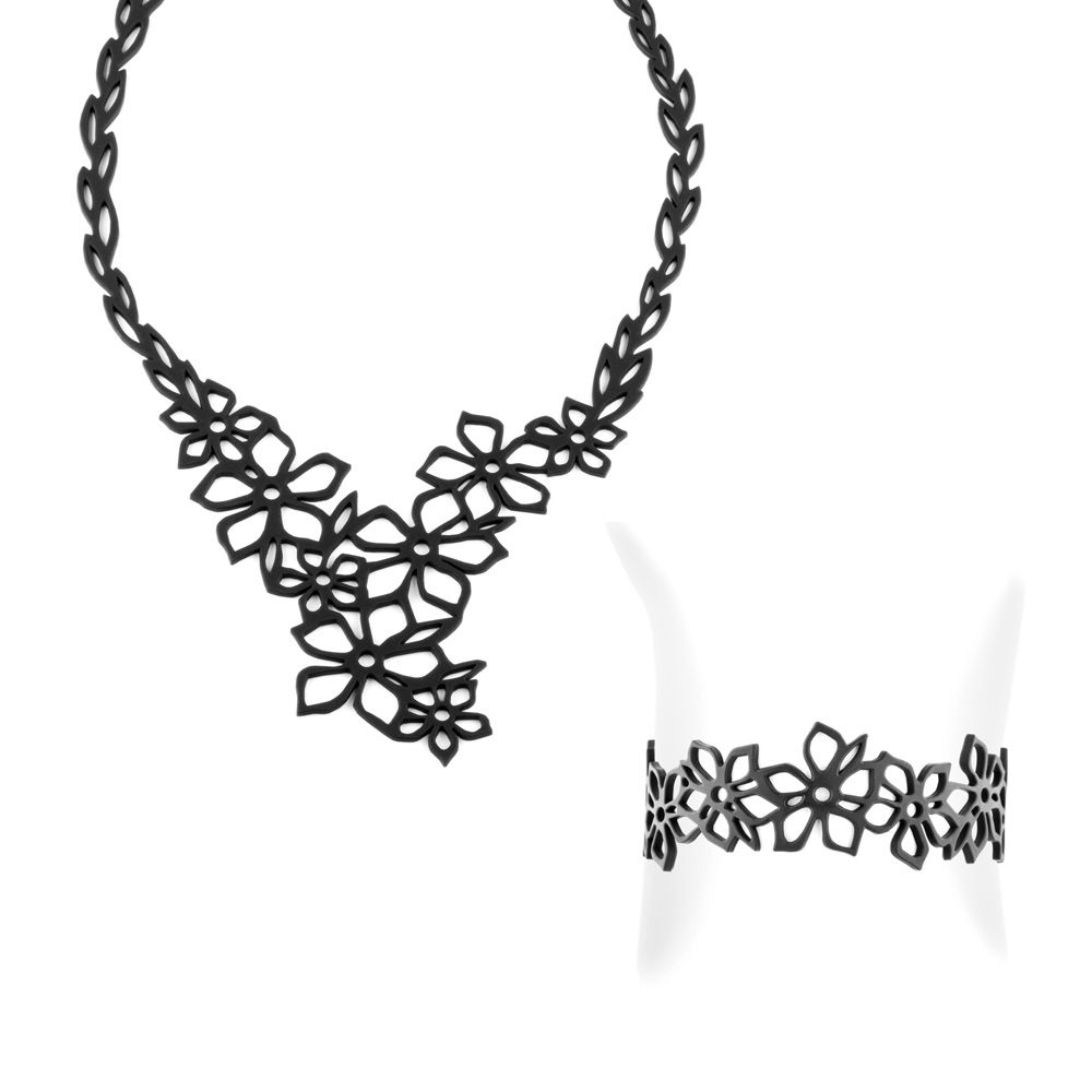 Black Silicone Gum Tiare Flower Necklace and Bracelet Set Effect Tatto Magnificent French creation with floral look. Made of black silicone gum it has many advantages. Anti allergic it will suit all people not supporting the metals. Very nice to wear this material is lightweight, very soft, like a second skin for a tattoo effect. Malleable and deformable, you can fold it, put it away, manhandle this jewel will resume its original shape. Ideal to take it anywhere with you. Very durable you can wear it in all circumstances as at the beach or pool. Description Necklace : Material : silicone Adjustable length: 35 to 45 cm Thickness: 2 mm Weight: 12 gr Description Bracelet : Material : silicone Adjustable length: 16 to 21 cm Thickness: 2 mm Weight: 9 gr Optional with or without crystal