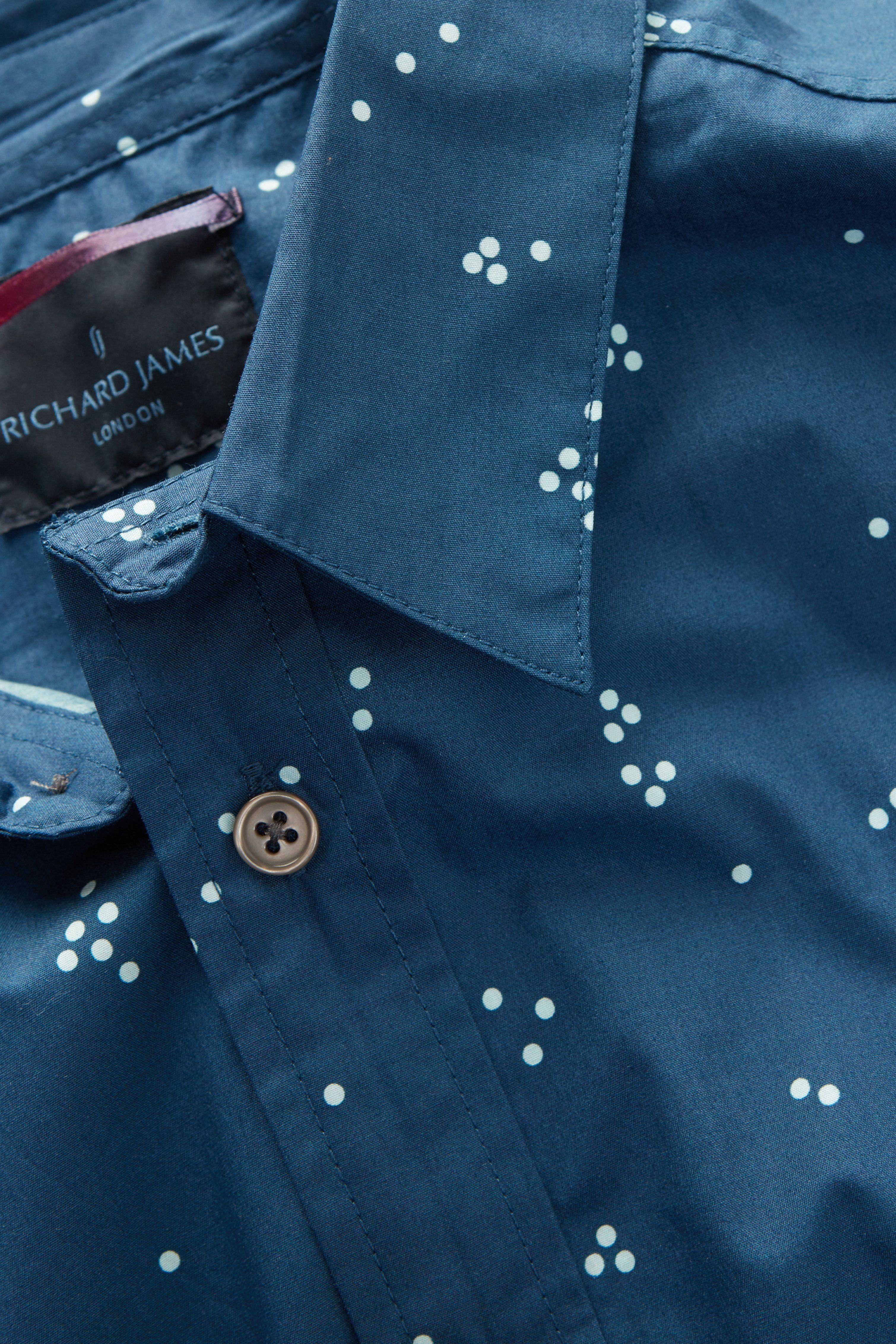 Random Dots Short Sleeve Shirt
RJL0047B
Button front short-sleeve printed shirt in plain weave cotton.
KEY: Everyday, Event, Lightweight. 
DETAIL: Seven-button front, soft collar, side vents, locker loop. 
FABRICATION: 100% cotton 
 