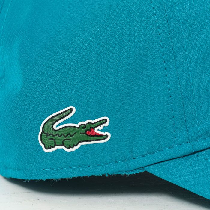 Mens Lacoste Baseball Cap  Turquoise. <BR><BR>- Adjustable strap.<BR>- Breathable eyelets. <BR>- Decorative overstitching. <BR>- Fabric sweatband built in.<BR>- Embroidered green crocodile on side. <BR>- Curved peak finish. <BR>- 100% polyester. Machine washable. <BR>- Ref: RK244700B9V