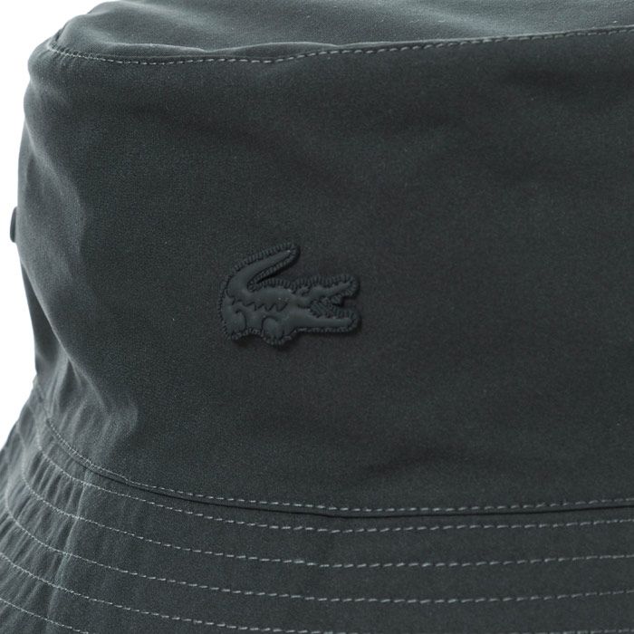 Mens Lacoste Reversible Bucket Hat  Charcoal.  <BR><BR>- Flat top Eyelet detail.<BR>- Embroidered logo detail.<BR>- Short brim.<BR>- 100% polyamide. Machine washable. <BR>- Ref: RK8272001SU