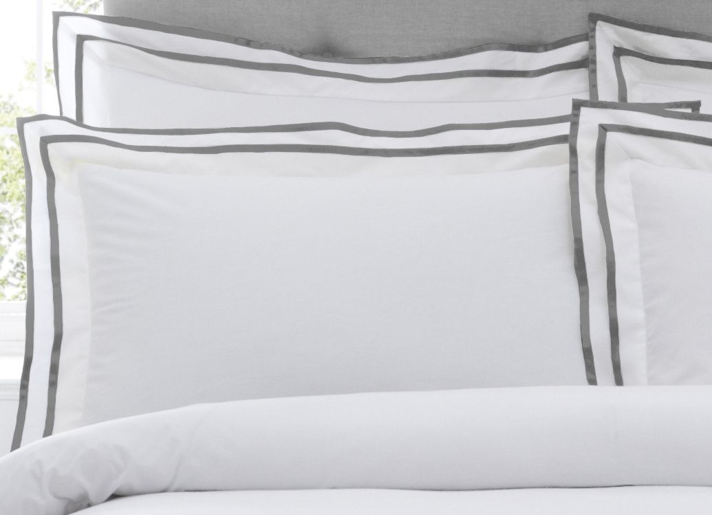 Nothing looks better than a crisp white pillowcase to lift your bedroom from being stale to giving it a breath of new life. The Sandringham pillowcase is made of 200 thread count, 100% cotton making it incredibly soft. This hotel-quality pillowcase boasts a double oxford border in two opulent colours for double the luxury. Complete with an envelope closure to keep your pillows in place. Suitable for everyday use this gorgeous pillowcase is fully machine washable and appropriate to iron. Iron damp for the best finish. Specifically made to match with the Sandringham duvet cover set.
