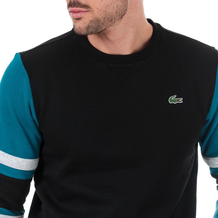 Mens Lacoste Sport Striped Sleeves Fleece Sweatshirt  Black. <BR><BR>- Brushed cotton blend fleece.<BR>-Ribbed crew neck with reinforcement.<BR>- Contrast sleeves with striped panels.<BR>- Ribbed finishes.<BR>- Green crocodile transfer on chest. <BR>- Measurement from shoulder to hem: 29“approximately. <BR>- Main fabric; cotton 83%  polyester 17%. Machine washable.<BR>- Ref: SH8654001WL