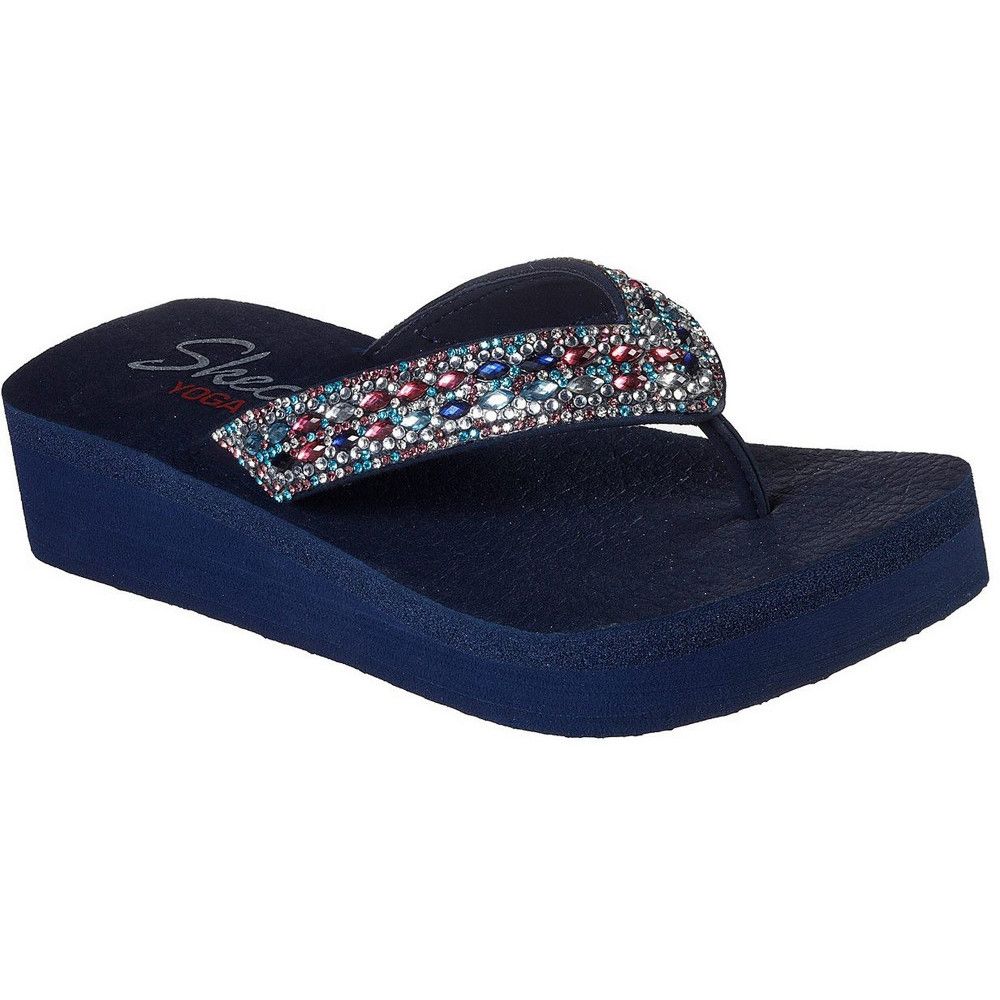 Don't let a chance to sparkle and charm pass you by wearing the Vinyasa Glory Day sandal. Smooth synthetic upper with rhinestone accents in a low wedge heeled flip flop casual thong sandal. YOGA FOAM comfort footbed.