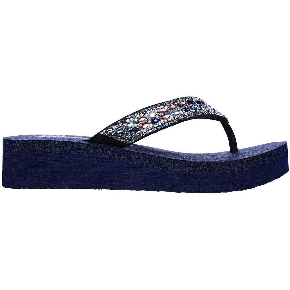 Don't let a chance to sparkle and charm pass you by wearing the Vinyasa Glory Day sandal. Smooth synthetic upper with rhinestone accents in a low wedge heeled flip flop casual thong sandal. YOGA FOAM comfort footbed.