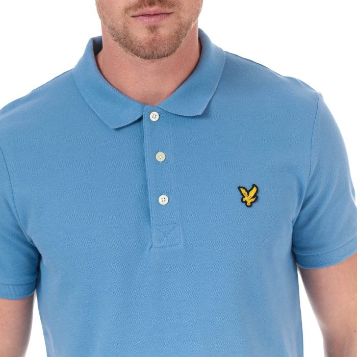 Mens Lyle And Scott Plain Polo Shirt in cornflower blue.<BR><BR>- Ribbed polo collar.<BR>- Three button placket.<BR>- Short sleeves with ribbed cuffs.<BR>- Even vented hem.<BR>- Embroidered eagle logo at left chest.<BR>- Woven herringbone back neck tape.<BR>- Regular fit.<BR>- 100% Cotton piqué.  Machine washable.<BR>- Ref: SP400VTR030