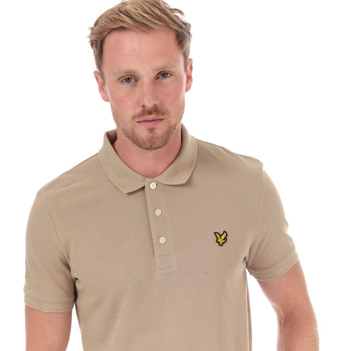 Mens Lyle And Scott Plain Polo Shirt in stone.<BR><BR>- Ribbed polo collar.<BR>- Three button placket.<BR>- Short sleeves with ribbed cuffs.<BR>- Even vented hem.<BR>- Embroidered eagle logo at left chest.<BR>- Woven herringbone back neck tape.<BR>- Regular fit.<BR>- 100% Cotton piqué.  Machine washable.<BR>- Ref: SP400VTRZ151