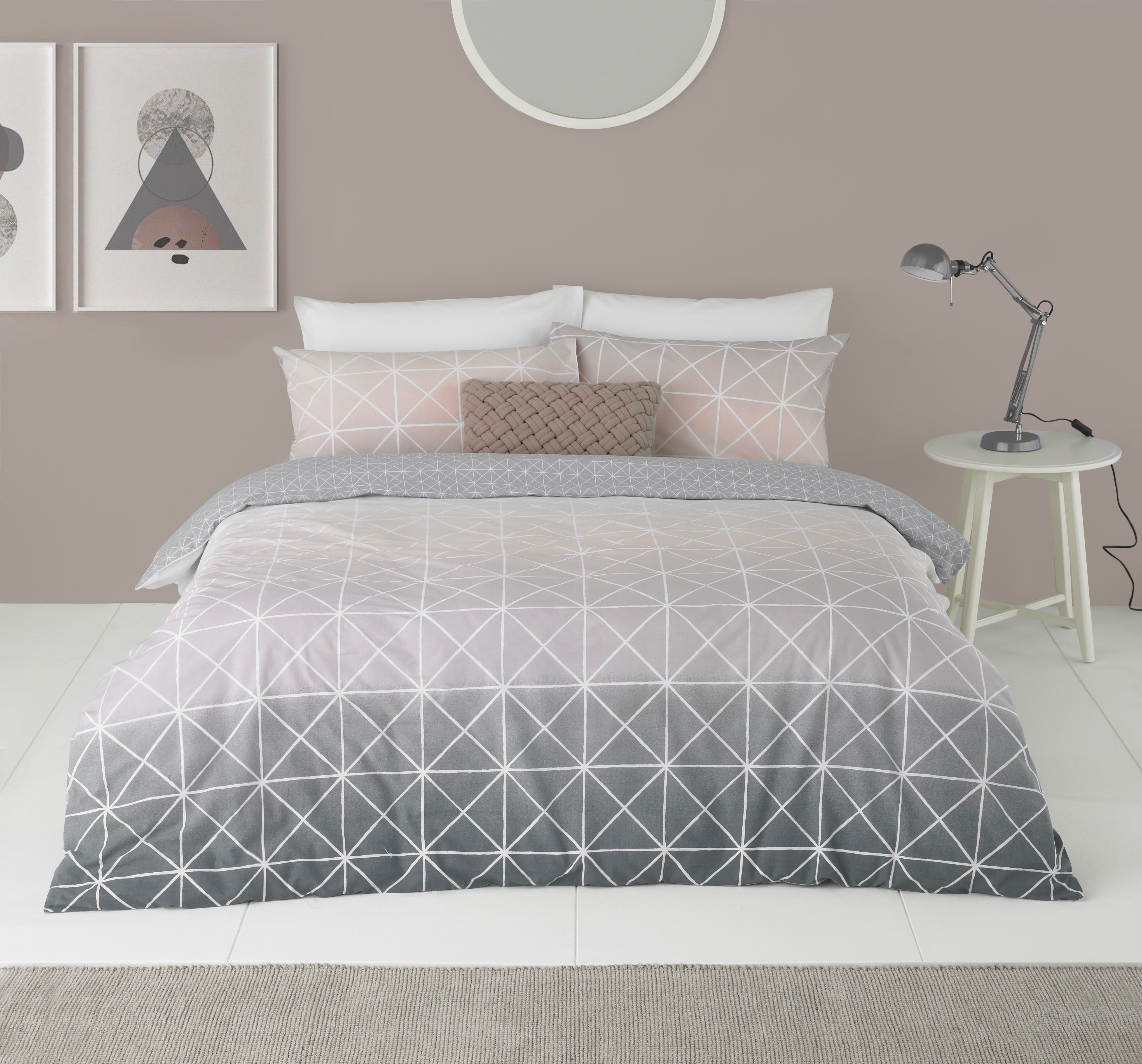 Featuring a gorgeous gradient flowing from a crisp white, to soft pink and finishing on a beautiful grey the Spectrum duvet cover set is a versatile piece. Complete with thin white lines in a geometric pattern it brings a modern touch that will elevate your bedroom into a contemporary space. The reverse has a matching plain grey with white dots to neutralise the statement front. Each duvet set comes with matching pillowcases with a reversible design. Made of crisp polycotton making this duvet set soft and hard-wearing. This duvet cover features a secure button closure while the pillowcases have an envelope closure. Machine washable on a 40 degree cycle. Iron cool and tumble dry on a low setting for the best finish.