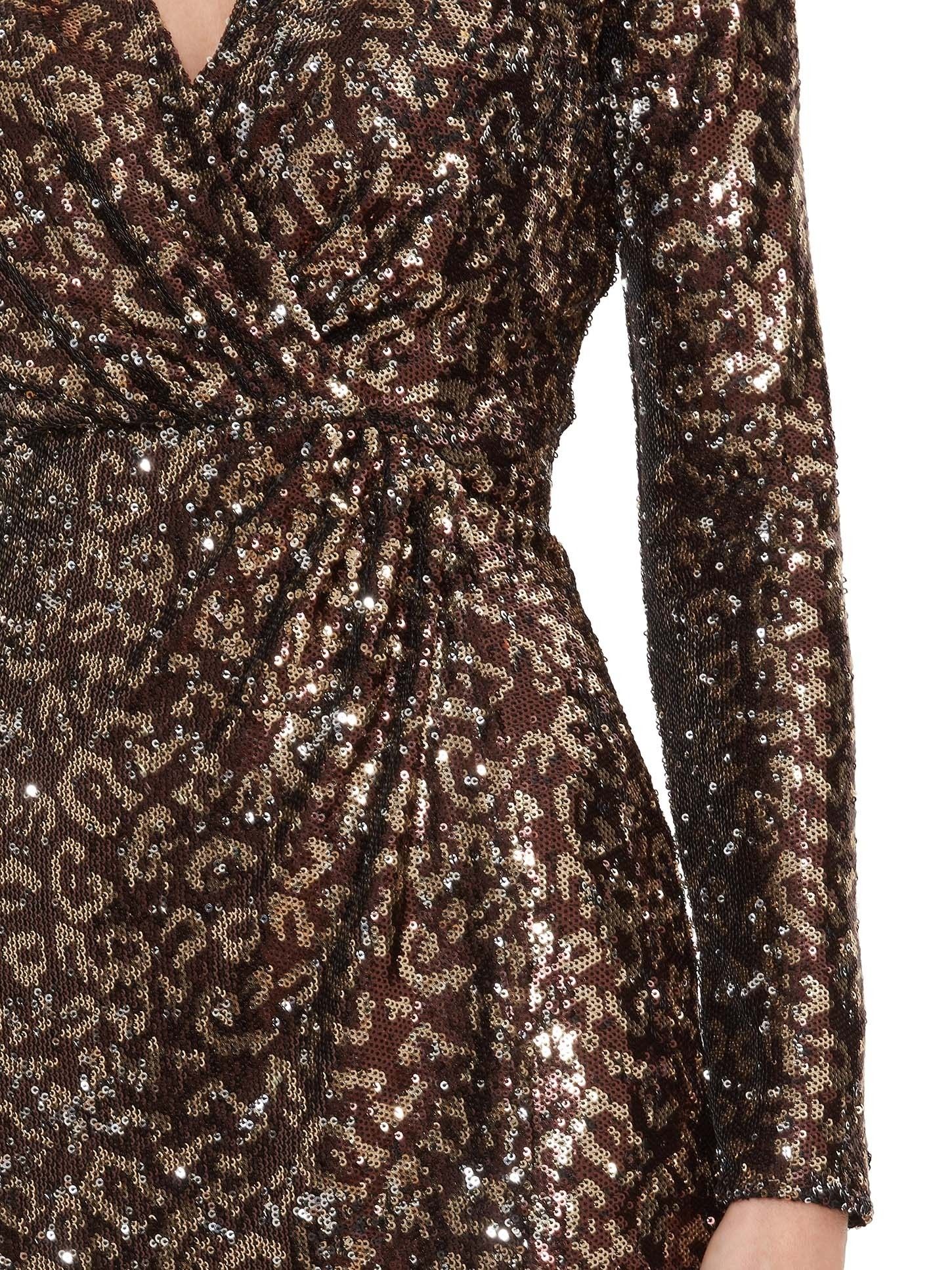 This gorgeous wrap dress by Gina Bacconi is sure to make you stand out. This low cut sequin dress is perfect for a party or special occasion. With ruching and a split hem for a classic look.