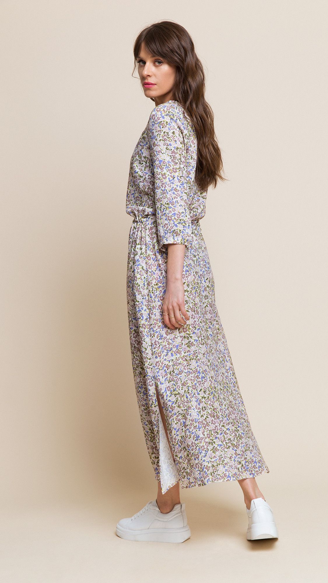 Nancy is a classic ⅞ dress with a V-neck, 3/4 sleeves fastened with a button, two slits and hidden pockets. At the waist it is tied with a delicate string, which you can use to adjust the dress to the shape of your figure. Available in three different floral prints, from light beige to black.