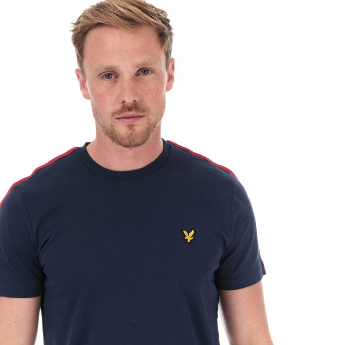 Mens Lyle And Scott Taped T-Shirt in navy - gala red.<BR><BR>- Ribbed crew neck.<BR>- Short sleeves.<BR>- Retro-inspired two-tone tape at shoulders and sleeves.<BR>- Embroidered eagle logo at left chest.<BR>- Woven herringbone back neck tape.<BR>- Soft cotton jersey construction.<BR>- Regular fit.<BR>- 100% Cotton. Machine washable.<BR>- Ref: TS1235VZ857