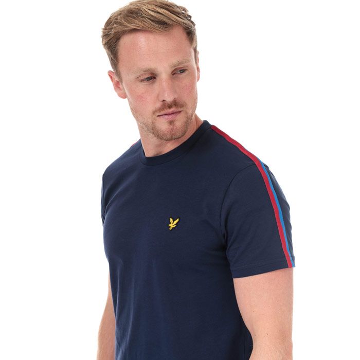Mens Lyle And Scott Taped T-Shirt in navy - gala red.<BR><BR>- Ribbed crew neck.<BR>- Short sleeves.<BR>- Retro-inspired two-tone tape at shoulders and sleeves.<BR>- Embroidered eagle logo at left chest.<BR>- Woven herringbone back neck tape.<BR>- Soft cotton jersey construction.<BR>- Regular fit.<BR>- 100% Cotton. Machine washable.<BR>- Ref: TS1235VZ857