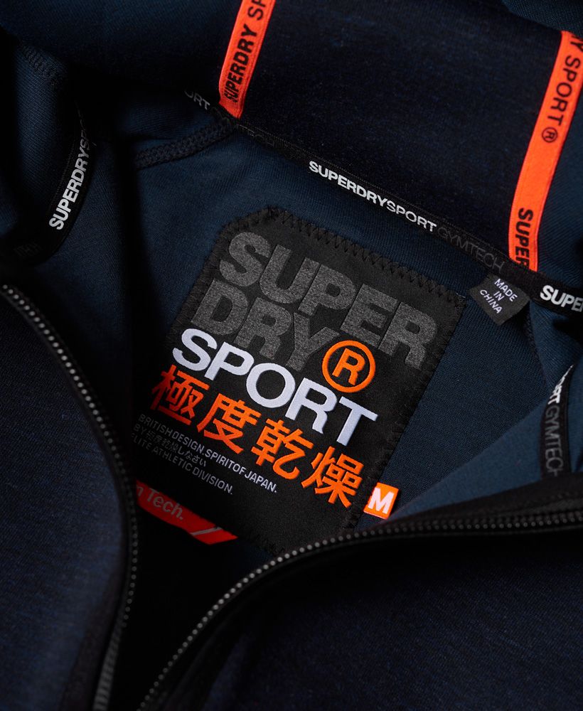 The Tech range from the Superdry Sport collection has a slimmer fit and is designed to be worn as a warm up/warm down layer over the Runner range. Cool, comfortable and on top of your game! Superdry’s brand new sport collection for men is designed for high performance.Superdry men’s gym tech zip hoodie. This zip hoodie features a bungee cord adjustable hood, ribbed cuffs and hem and a front zip fastening. Featuring two front pockets and one back pocket this gym tech hoodie has Superdry sport brand detailing on the zipped pockets and bungee cord. Model wears: Medium Model height: 6’ 1” (185cm) Model chest size: 38