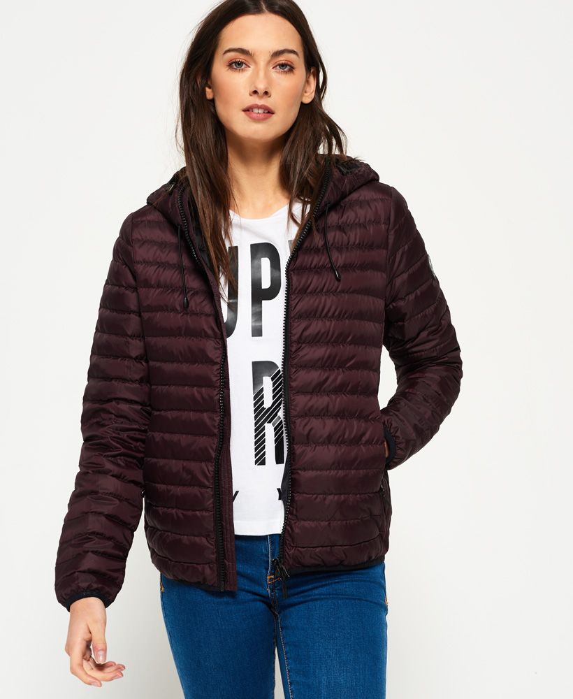 Superdry women’s Core down hooded jacket. This lightweight, quilted jacket is the perfection transitional wardrobe piece and features a 90/10 premium duck down filling for fantastic insulation, keeping you warm in extreme cold with a very high fill power rating. The jacket also features an elasticated hood, cuffs and hem, zip fastening and two front pockets. The Core down hooded jacket is finished with branded zip pulls and a rubber Superdry logo badge on one sleeve. Superdry is certified by the Responsible Down Standard to confirm that our down filled products are sourced to ensure animal welfare. Model wears: Small Model height: 5’ 8” (173cm) Model chest size: 33