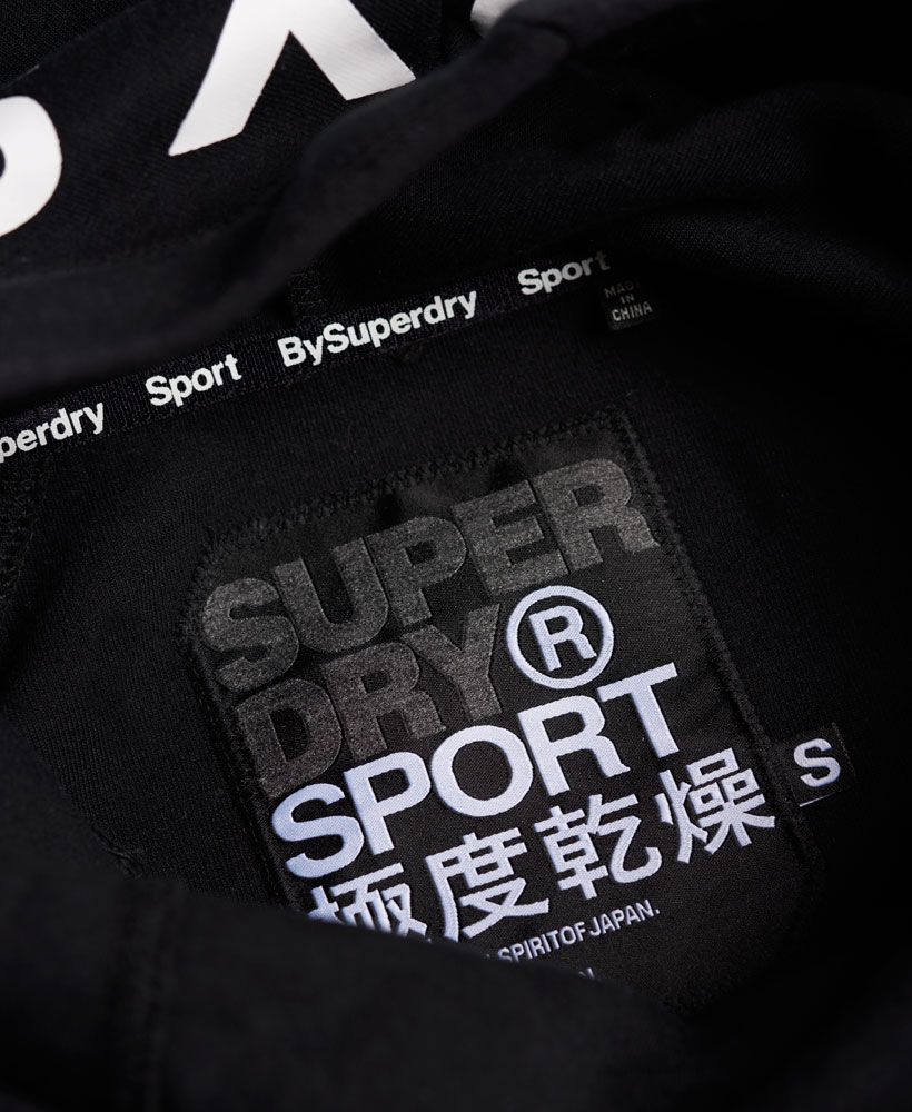 Superdry’s latest Sport Collection is this season’s must-have, combining hi-tech fabrics for professional performance fused with vivid Superdry detailing to create the ultimate fitness look. 
 Superdry women's Gym Tech Cowl Hoodie. Featuring breathable and technical bonded jersey the hoodie benefits from one front pocket with Superdry Sport printed zips and an adjustable bungee cord cowl style hood. Finished with an embossed Superdry Sport print on the back hood, it is also subtly branded with Superdry Sport hems and is designed for exercising outdoors. Model wears: Small Model height: 5’ 10” (175cm)