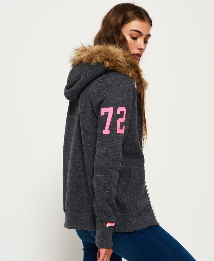 Superdry women’s Track & Field Super Track Zip Hoodie. Feel comfortable and cosy in this Track & Field zip hoodie, featuring a Sherpa lined hood with a faux fur trim and fleeced lined inside. Featuring long sleeves with ribbed cuffs, hem and two front pockets. Finished with a cracked Superdry logo on the chest and Superdry logo tab on the cuff.Model wears: Small Model height: 5’ 8” (173cm) Model chest size: 33