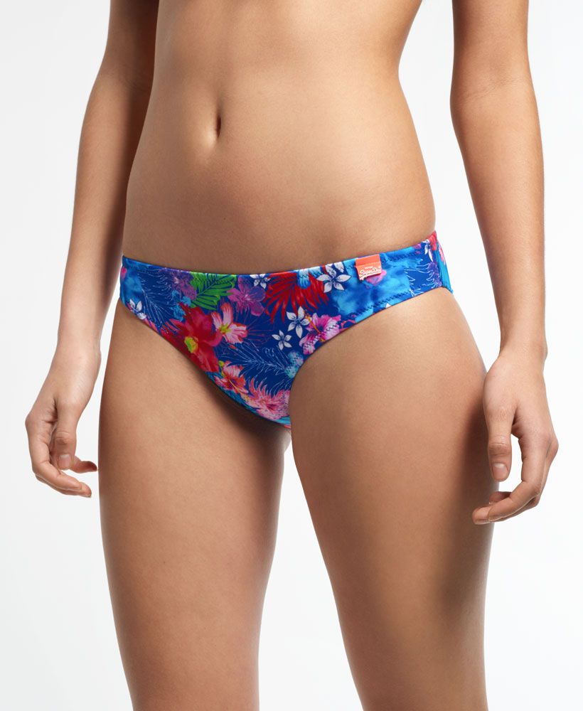 Superdry women's Hot Tropic bikini bottoms. Classic bikini bottoms featuring an all over tropical style design and finished with a small rubber Superdry logo on the hip.  Please note due to hygiene reasons, we are unable to offer an exchange or refund on swimwear unless they are sealed in their original packaging. This does not affect your statutory rights.Model wears: Small Model height: 5’ 10” (178cm)