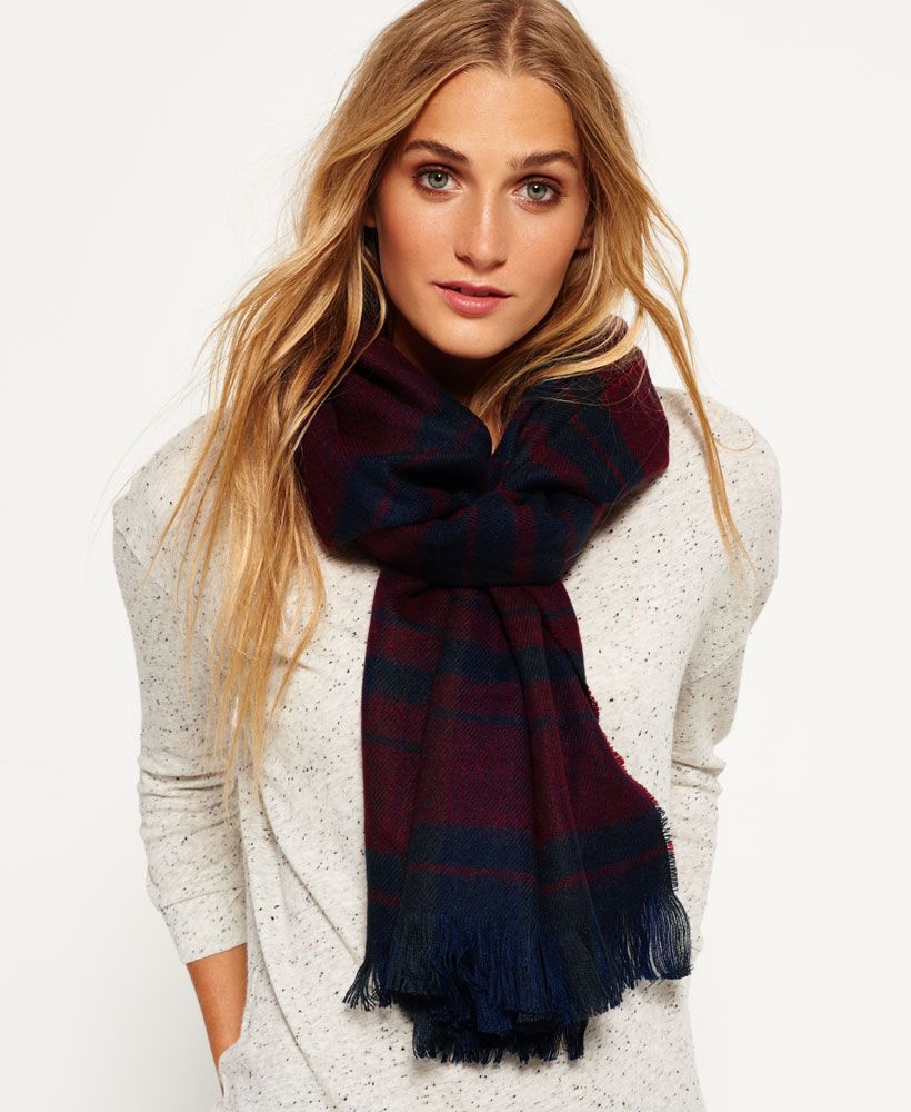 Superdry women's Capital Scarf. A lightweight scarf featuring a tri colour tartan style pattern all over, frayed ends and is finished with a large Superdry Limited logo patch on one end.