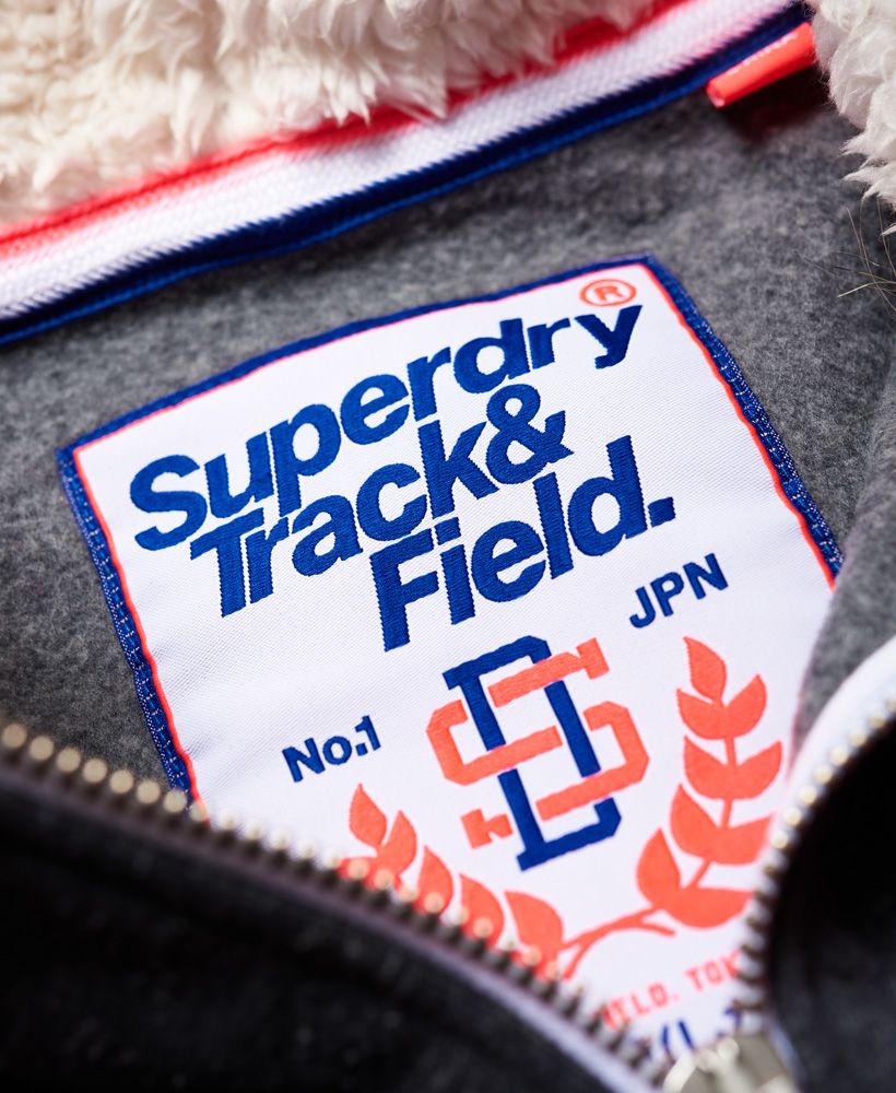 Superdry women’s Track & Field Super Track Zip Hoodie. Feel comfortable and cosy in this Track & Field zip hoodie, featuring a Sherpa lined hood with a faux fur trim and fleeced lined inside. Featuring long sleeves with ribbed cuffs, hem and two front pockets. Finished with a cracked Superdry logo on the chest and Superdry logo tab on the cuff.Model wears: Small Model height: 5’ 8” (173cm) Model chest size: 33