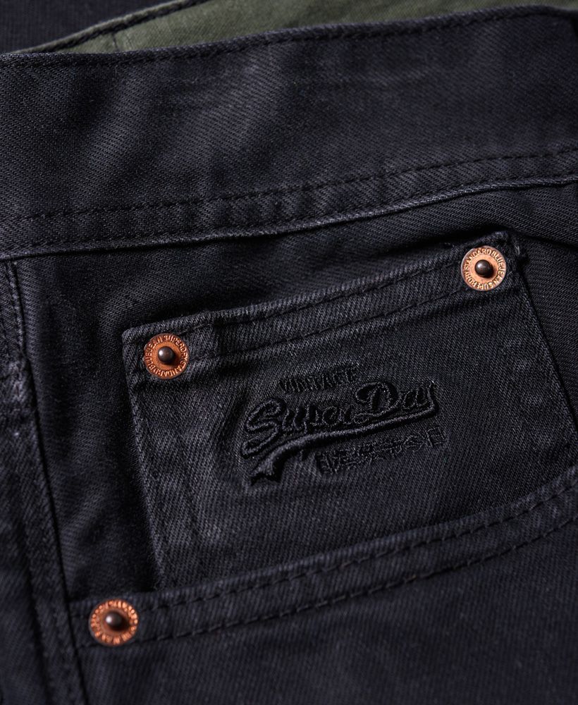 Superdry men’s Loose Jeans. A pair of relaxed fit denim exclusive indigo jeans in the classic five pocket design with a button fly. The jeans feature a Vintage Superdry logo on the coin pocket. The Loose jeans are finished with a Superdry logo badge on the back waistline and a Superdry logo tab on the back of the pocket. 
Model wears: 32/32 Model height: 6’ 1” (185cm)