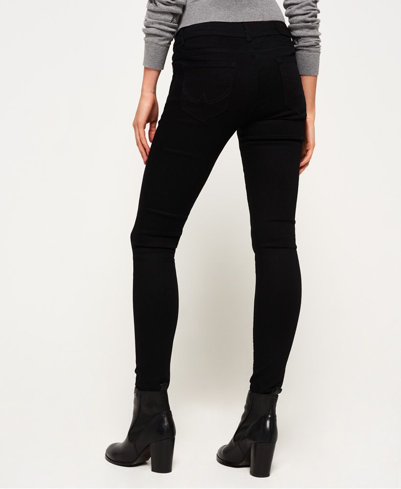 Superdry women's Cassie Skinny Jeans. A pair of mid-rise skinny fit jeans featuring the classic five pocket design, a button fly fastening and belt loops. The Cassie Skinny jeans are finished with a Superdry Denim patch on the coin pocket and an embossed logo patch on the back waistline.Model wears: 28/30Model height: 5’ 10” (178cm)Skinny Fit. Fitting where they touch, as that’s what they’re designed to do. With a hint of stretch just to make sure, they’re cut to cling close, right from your seat through the thigh and down to a narrow ankle – the ultimate rock star look.