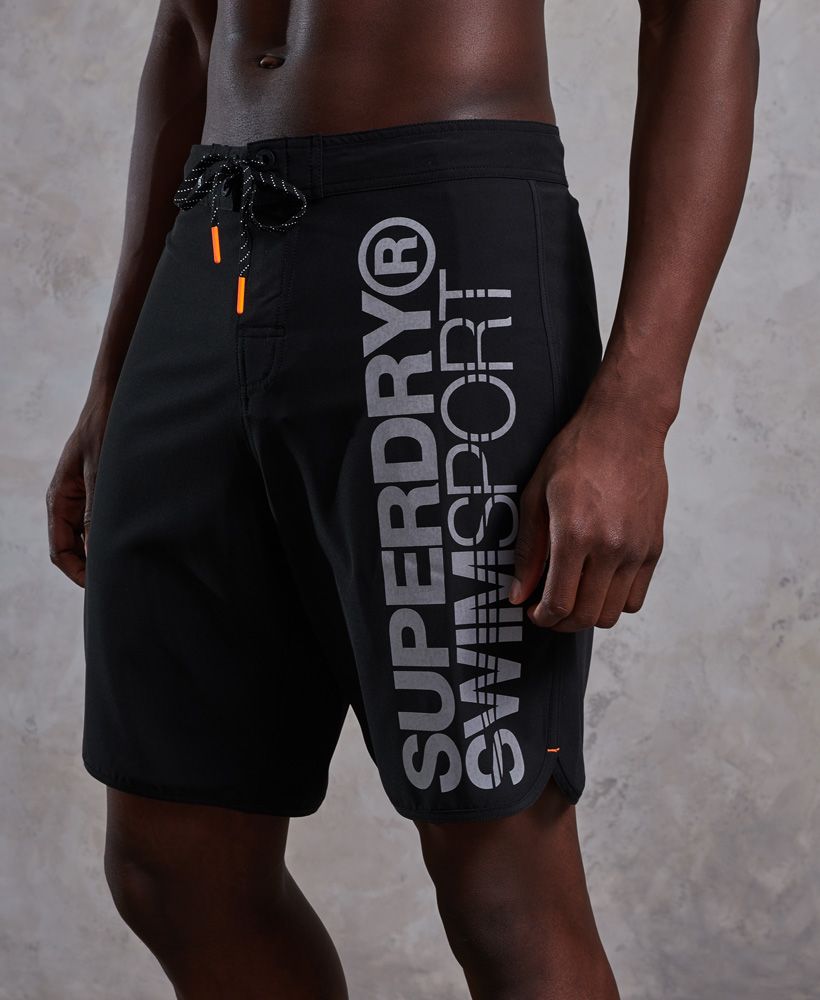 Superdry men’s Deep-Water Board shorts. Ideal for swimming and made from 4-way stretch fabric, these board shorts feature hook & loop and lace fastening and one back pocket. The board shorts and finished with a rubber Superdry logo tab on the waist and a Superdry swimsport logo print along one leg.Please note due to hygiene reasons, we are unable to offer an exchange or refund on swimwear, unless they are sealed in their original packaging. This does not affect your statutory rights.