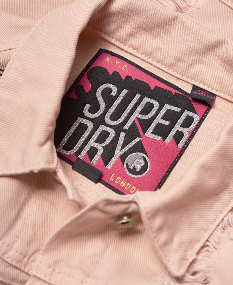Superdry women’s girlfriend jacket. This cropped denim jacket features a button fastening, four front pockets and buttoned cuffs. The girlfriend jacket is finished with a small, metal Superdry logo badge on one of the chest pockets.

Model wears: 10/Small Model height: 5’ 6” (168cm) Model chest size: 34.5