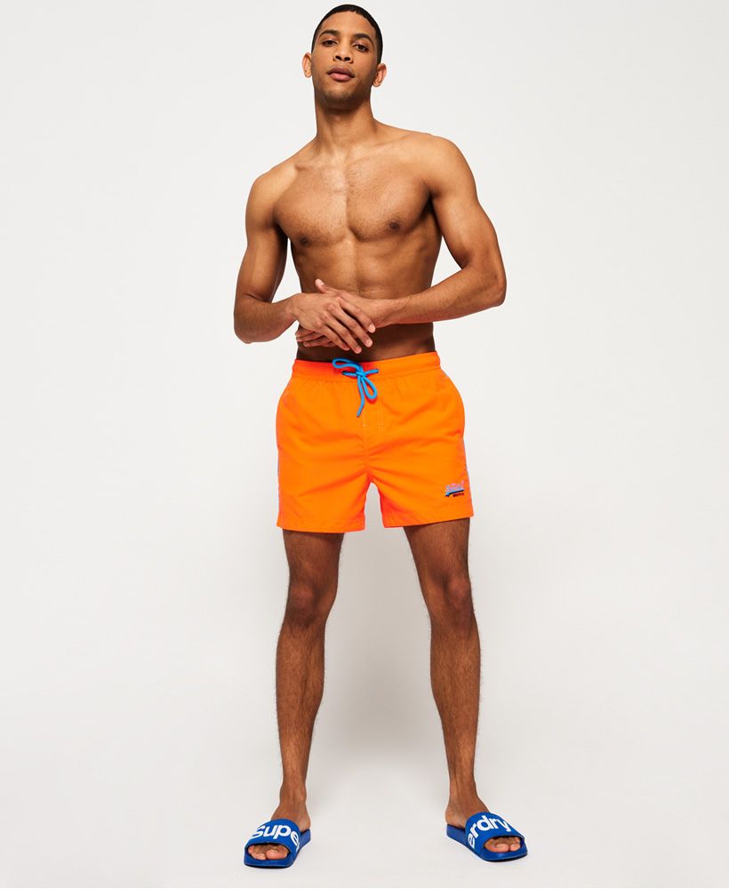 Superdry men’s Beach Volley swim shorts. These swim shorts feature a drawstring adjustable waist, a full mesh lining and two front pockets and one zip fastened one at the rear. The Beach Volley swim shorts are finished with an embroidered Superdry logo above the hem.