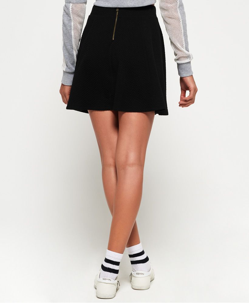 Superdry women’s Sophia textured skater skirt. Featuring a textured feel, an elasticated waistband and zip fastening on the reverse. The Sophia skirt is finished with a subtle metal badge just above the hem. Pair with heeled boots or sandals for a look that can be worn all year round.