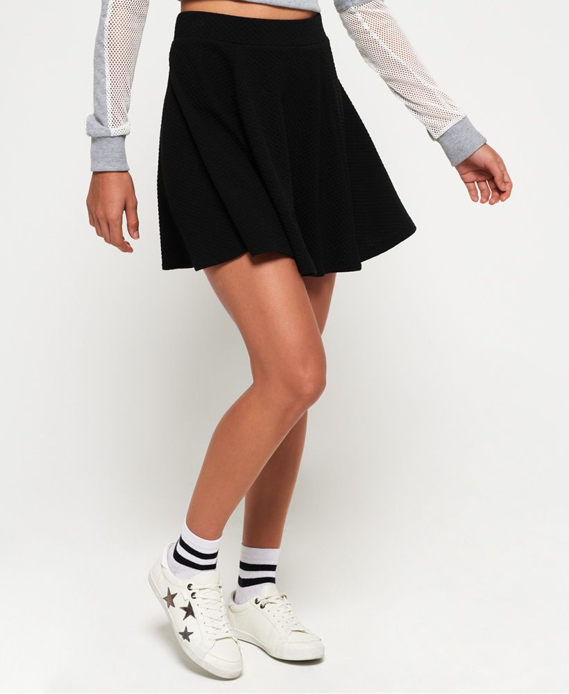 Superdry women’s Sophia textured skater skirt. Featuring a textured feel, an elasticated waistband and zip fastening on the reverse. The Sophia skirt is finished with a subtle metal badge just above the hem. Pair with heeled boots or sandals for a look that can be worn all year round.