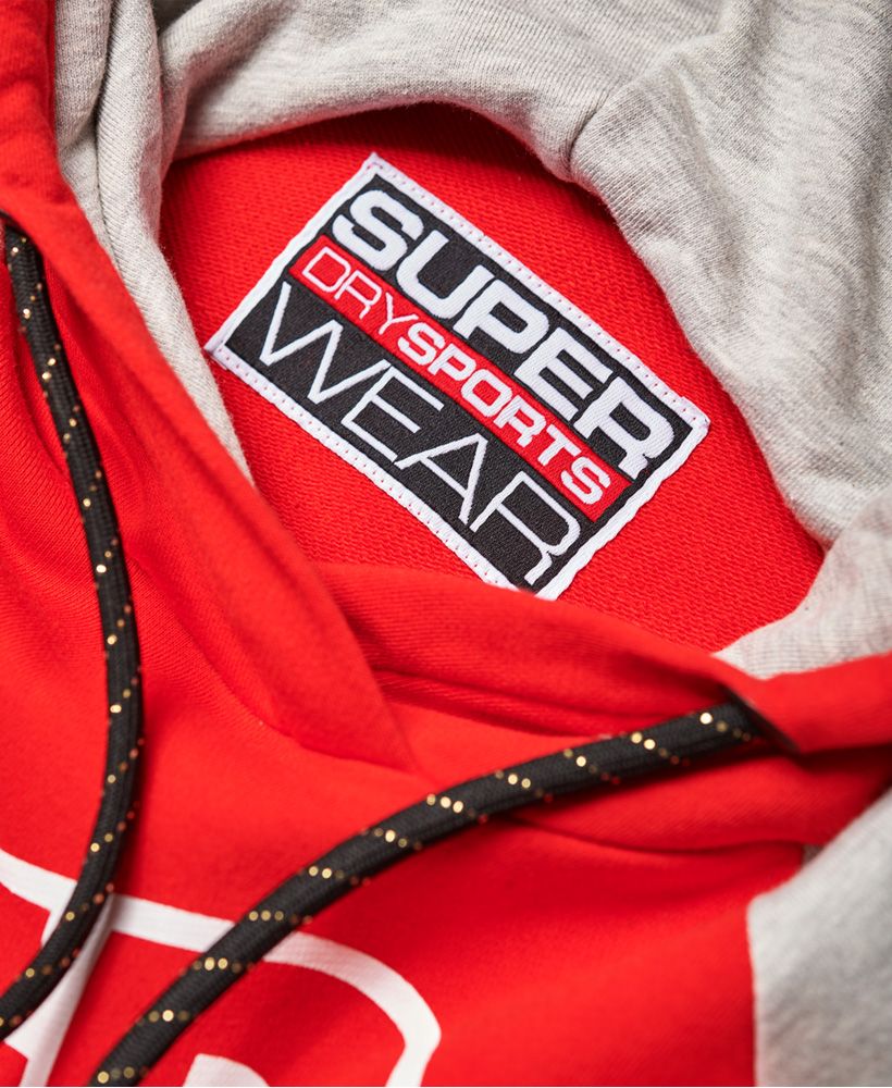 Superdry women’s Street Sports hoodie. The perfect on-trend addition to your wardrobe, this comfortable hoodie features a drawstring adjustable hood and a large diagonal Superdry Sport logo design across the front with a metallic finish. The Street Sports hoodie is finished with a contrasting panel on the shoulder, stripe design down the sleeves and a ribbed hem and cuffs.
