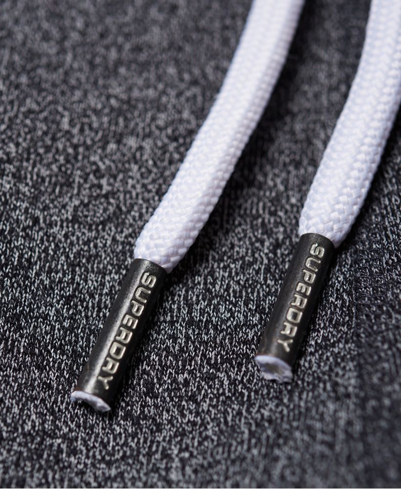 Superdry men’s Track & Field joggers. These joggers feature an adjustable drawstring waist, two front pockets and one rear pocket. The Track & Field joggers are finished with the Superdry logo designs on both legs and a Superdry logo tab on the rear pocket.Slim fit