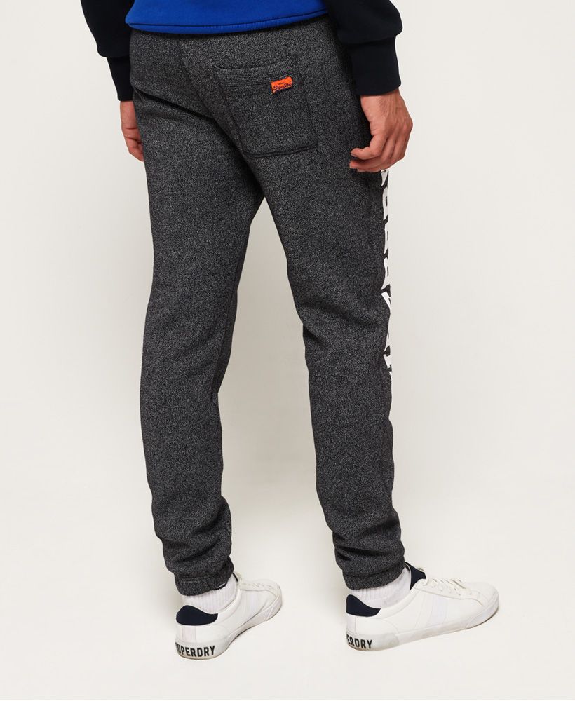 Superdry men’s Track & Field joggers. These joggers feature an adjustable drawstring waist, two front pockets and one rear pocket. The Track & Field joggers are finished with the Superdry logo designs on both legs and a Superdry logo tab on the rear pocket.Slim fit