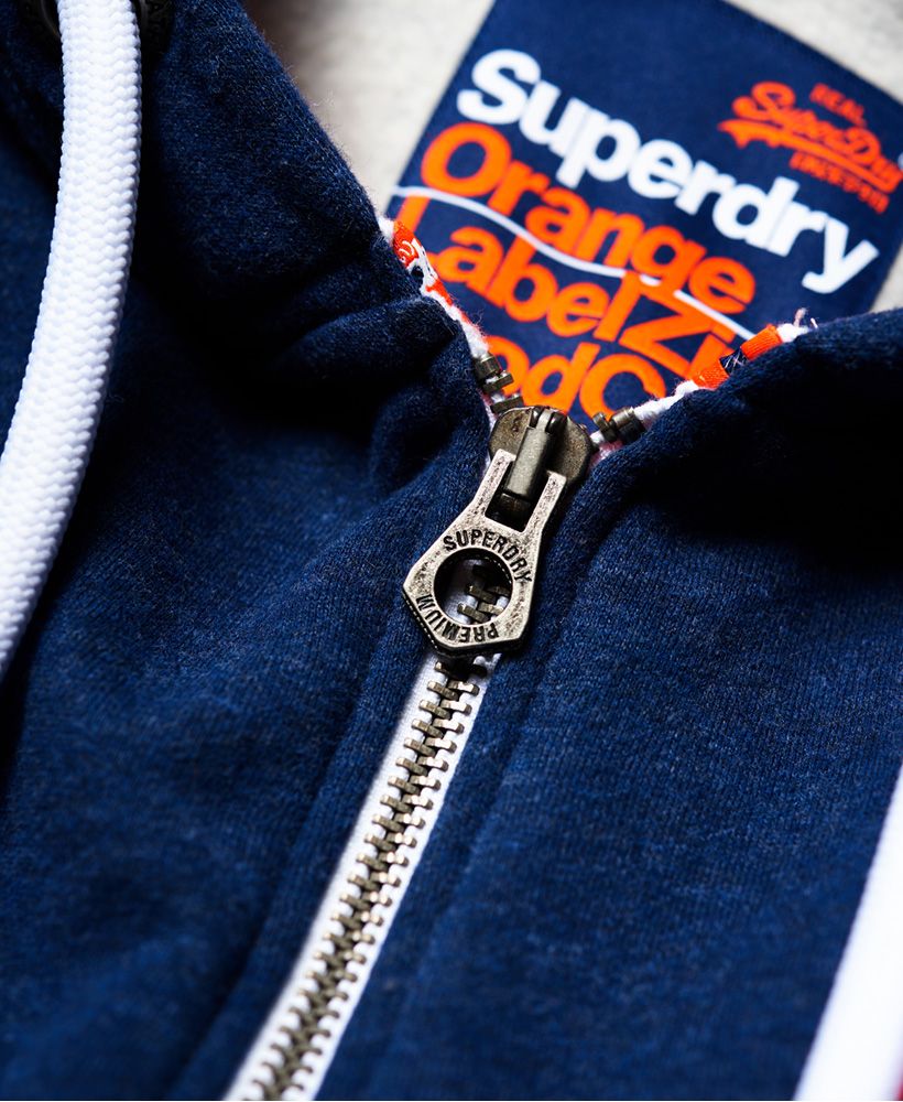 Superdry men’s zip hoodie from the Orange Label range. This hoodie is great for layering this season, it features the iconic Superdry logo embroidered on the chest, two front pockets and a drawstring hood. This hoodie has been finished with a Superdry tab on the cuff, ribbed hem and cuffs for a flattering fit and an orange tab in the seam.