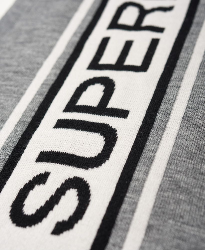Superdry men’s Oslo racer scarf. Wrap up warm this season with the Oslo racer scarf. The scarf features a stripe design with Superdry logo and will be the perfect finishing touch to any outfit this season.
