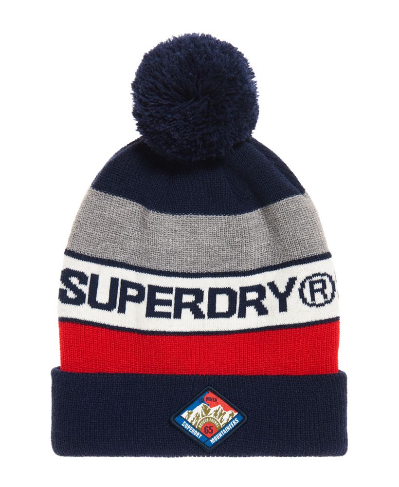 Superdry men’s Trophy beanie. This classic turn up bobble beanie is a great addition to your wardrobe this season to keep you warm whilst still looking stylish. Featuring three colour panels, a Superdry logo incorporated in the stripe design and a Superdry Mountaineers patch on the hem.