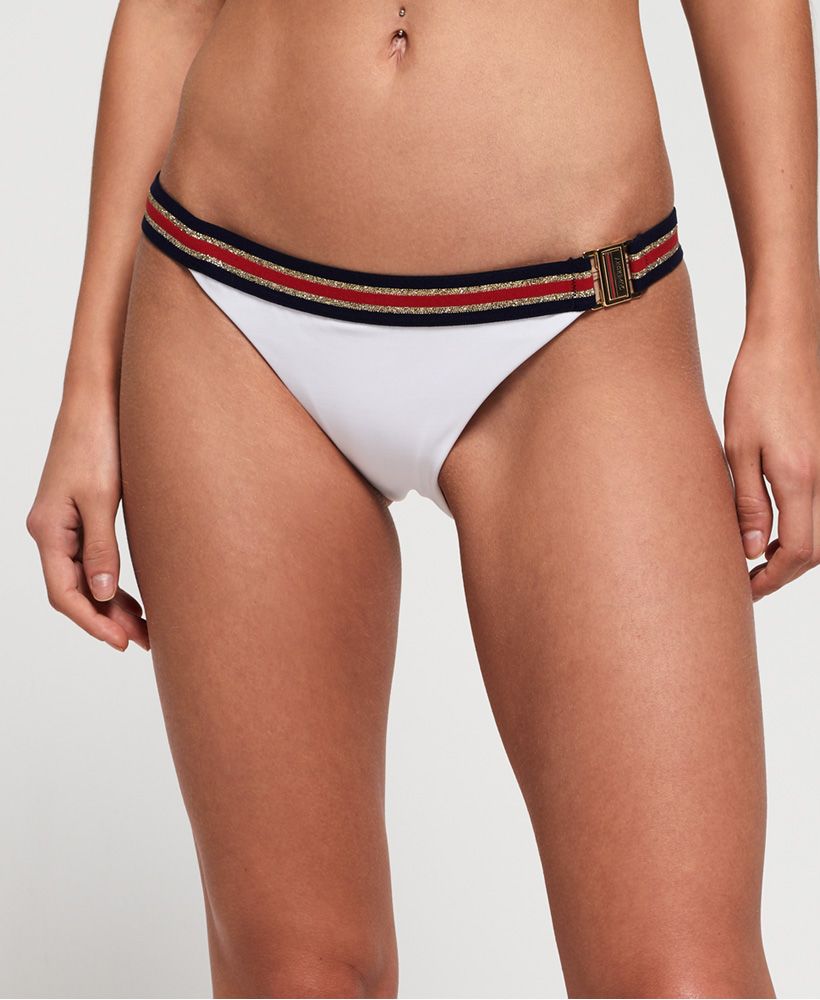 Superdry women's Crest logo fixed tri bikini bottom. This bikini bottom features an elasticated waist band with a side clasp fastening. Finished with a Superdry graphic across the back.Matching top available.Please note due to hygiene reasons, we are unable to offer an exchange or refund on swimwear, unless they are sealed in their original packaging. This does not affect your statutory rights.