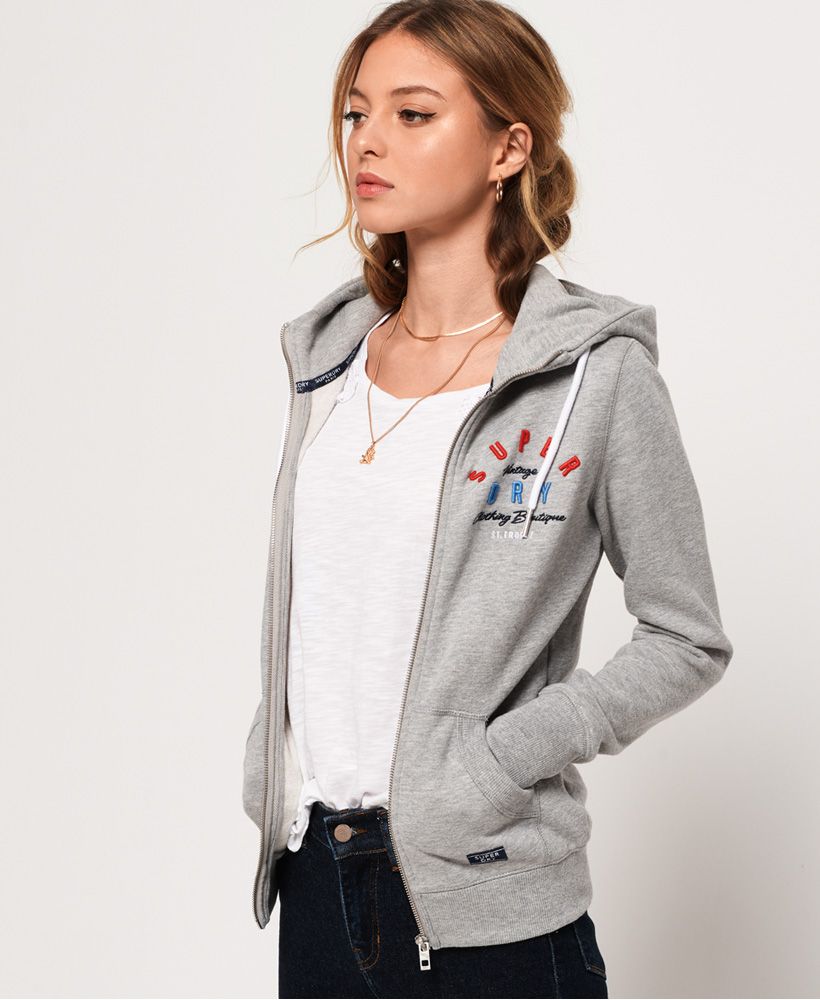 Superdry women's Applique zip hoodie. This hoodie features two front pockets, front zip fastening, drawstring hood and ribbed cuffs and hem. Finished with a Superdry logo on the chest and logo badge on pocket. Pair this hoodie with a pair of jeans for a casual look this season.