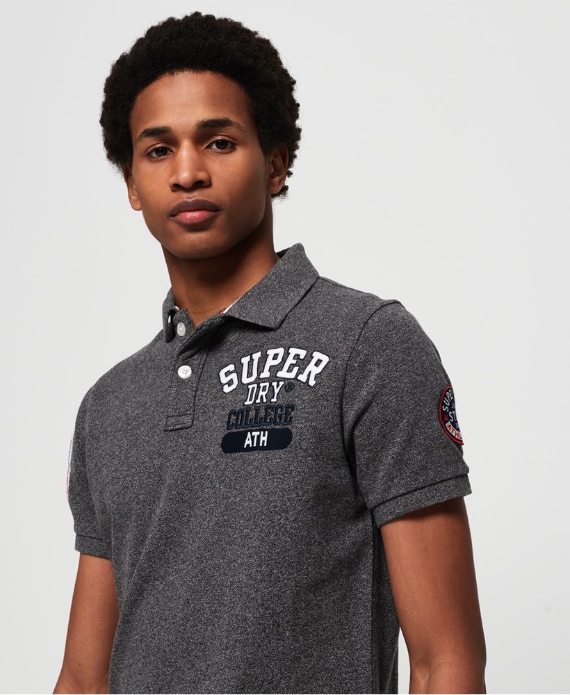 Superdry men’s Classic Superstate pique polo shirt. Made with cotton, this polo shirt features duo button fastening, an embroidered Superdry logo design on the chest and applique logo detailing on both sleeves. This must-have polo shirt is completed with split side seams and a logo tab on the hem. Slim fitMade with Organic Cotton - Made using cotton grown using organic farming methods which minimise water usage and eliminate pesticides, maximising soil health and farmer livelihoods.